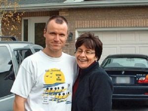Williams and his wife. Behind Williams is his pathfinder, the vehicle he used to transport the body of Jessica Lloyd. 